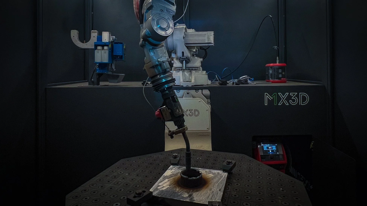 ロボットアームが金属部品を溶接または3Dプリンティングしている様子