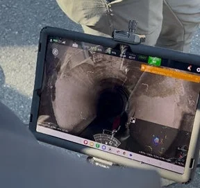 タブレットで管路内部の映像を確認する様子