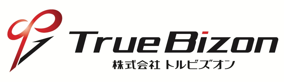 「TrueBizon」という英語表記と「株式会社 トルビズオン」という日本語表記が併記された企業のロゴです。赤と黒を基調としたスタイリッシュなデザインが特徴で、左側には抽象的なシンボルマークが配置されています。