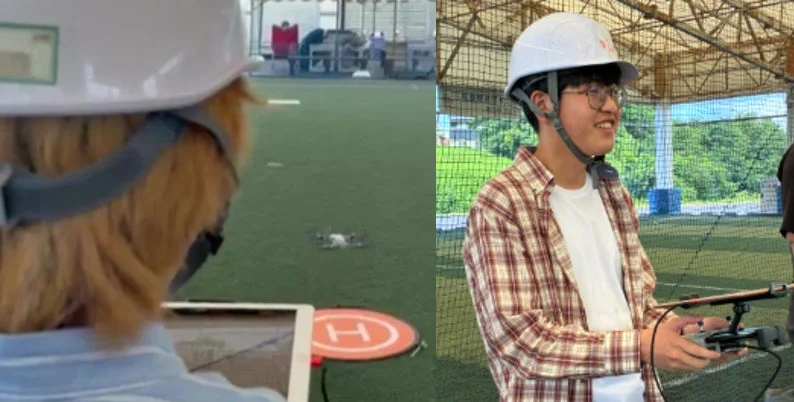ヘルメットを着用した2人の人物が屋内でドローンの操縦練習をしている様子